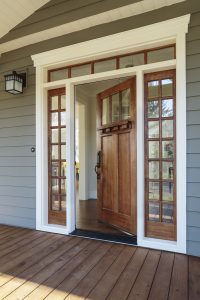 Exterior shot of an open Wooden Front Door, entry windows